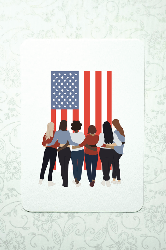 Six women, military spouses, of various races stand with arms around each other, gazing at the American flag 